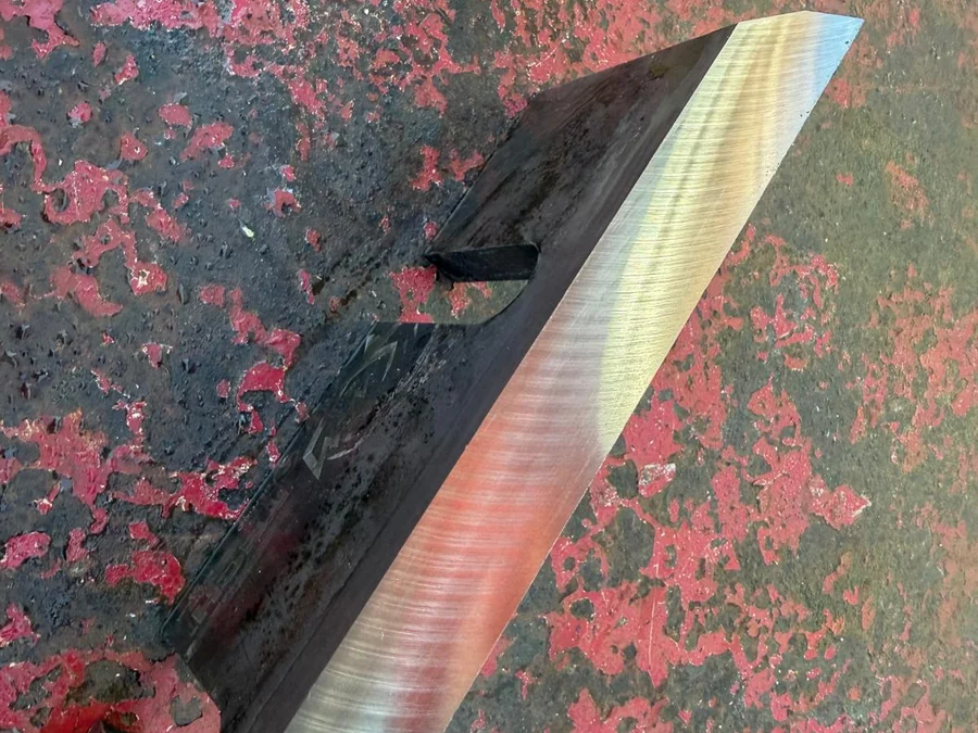 Close-up of a reground chipper blade bevel Close-up of the freshly ground bevel on a wood chipper blade showing the even grind marks along the edge